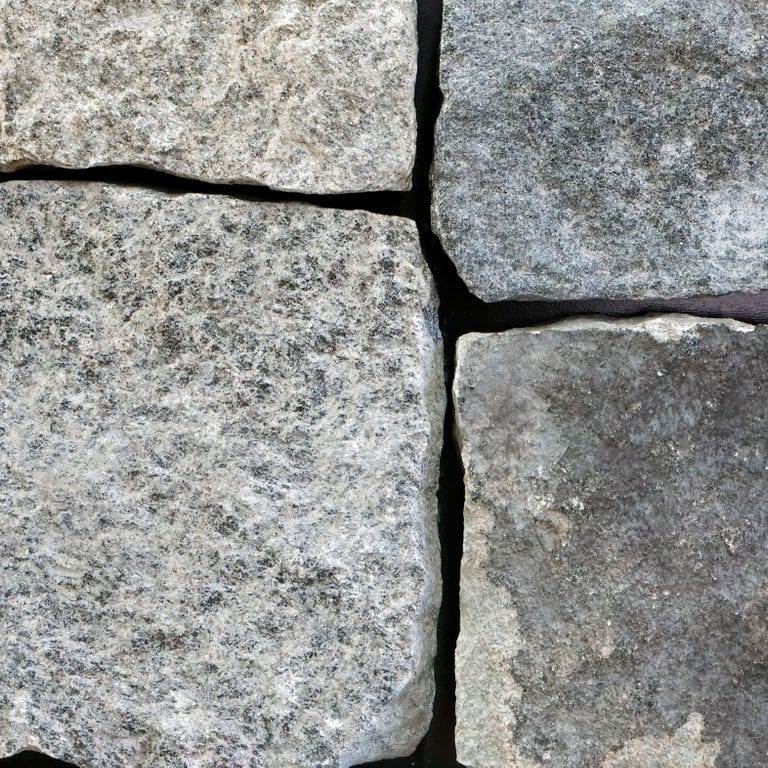 Feature image for Castleton Granite - Veneer - Seam/Bed Splitface. The image shows this product being used in a thin veneer application. The surface finish shown is . The dominant color shown is gray. The color mix creates a cool feeling. Regular and blotched color patterns.