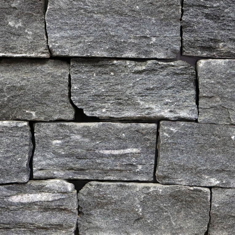 Feature image for Raven Hill Granite - Veneer - End Grain Split. The surface finish shown is split-face. The dominant color shown is gray. Exhibits "movement". Regular and linear color patterns. Contains mineral inclusions.