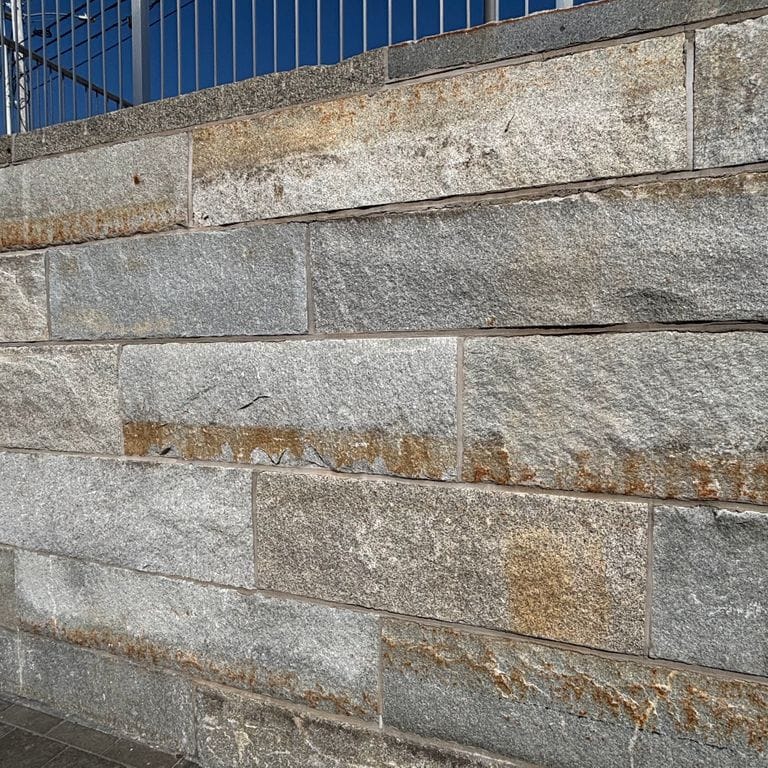 Application image for Reclaimed Granite Curbstone - Plank Veneer. The image shows this product being used in a full bed veneer application. The surface finish shown is . The dominant color shown is gray.