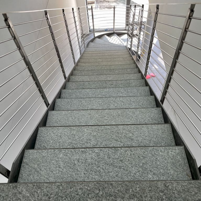 Application image for Pietra Italia Gray Gneiss - Treads. The image shows this product being used in a treads application. The surface finish shown is sand blasted. The dominant color shown is gray. The color mix creates a cool feeling.