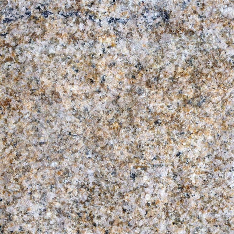 Swatch image for Granite - Golden Cobblestones. The surface finish shown is split-face. Dominant colors shown are beige, brown, gray and tan; with black, green, orange/rust, pink, purple, white and cream secondaries. The color mix creates a warm feeling. Speckled and random color patterns. Contains some mica and mineral inclusions.