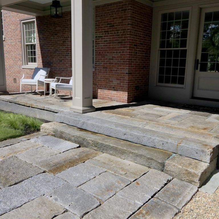 Application image for Reclaimed Granite Curbstone Plank Paver Mix - Random Widths and Lengths to 36". The image shows this product being used for path pavers and patio pavers. The surface finish shown is . The dominant color shown is gray. Speckled color pattern.