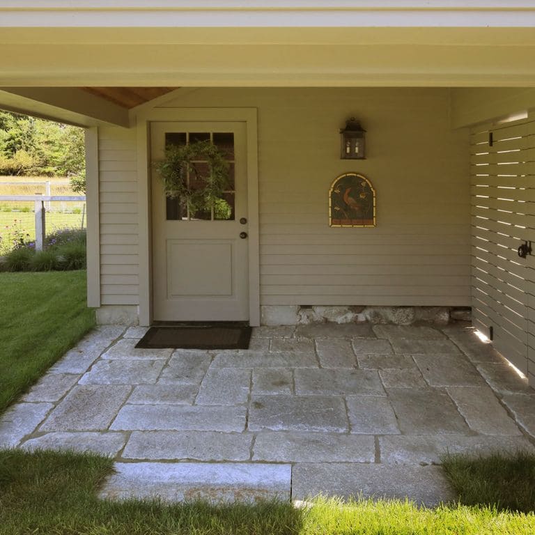Application image for Reclaimed Granite Curbstone Plank Paver Mix - Random Widths and Lengths to 36". The image shows this product being used in a patio pavers application. The surface finish shown is . The dominant color shown is gray. Speckled color pattern.