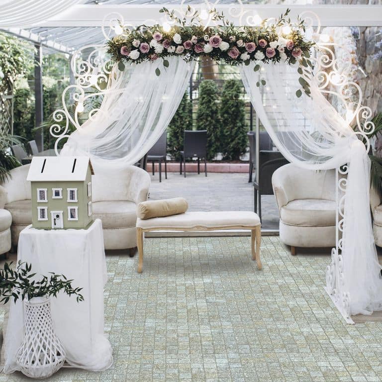 Application image for Pietra Italia Gneiss - Cobblestone Cubes. The image shows this product being used in a patio pavers application. Dominant colors shown are gray and tan. The color mix creates a warm feeling.