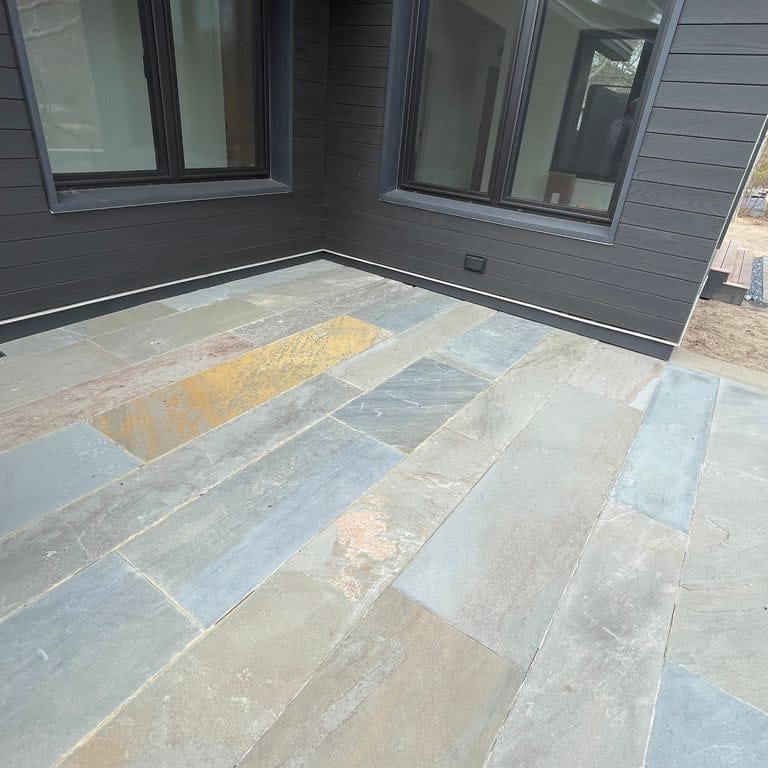 Application image for Bluestone Natural Cleft Full Color Mix - Plank Paver. The image shows this product being used in a patio pavers application. The surface finish shown is natural cleft. The dominant color shown is gray. The color mix creates a cool feeling.