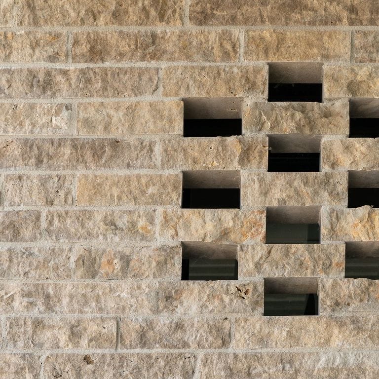 Application image for Bavarian Beige Limestone - Bavarian Brick. The image shows this product being used for full bed veneer and thin veneer. The surface finish shown is split-face. Dominant colors shown are beige and tan. The color mix creates a warm feeling.