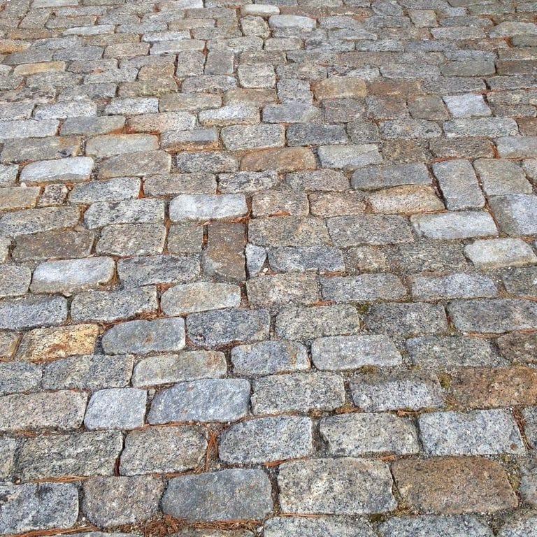 Best close-up image for Reclaimed New England Granite Cobblestone - Interior Flooring. The dominant color shown is gray.