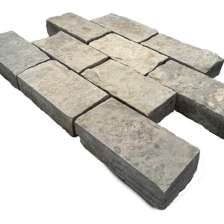 Feature image for Limestone - Reclaimed Rochester Pavers. The surface finish shown is split-face. The dominant color shown is gray. The color mix creates a warm feeling.