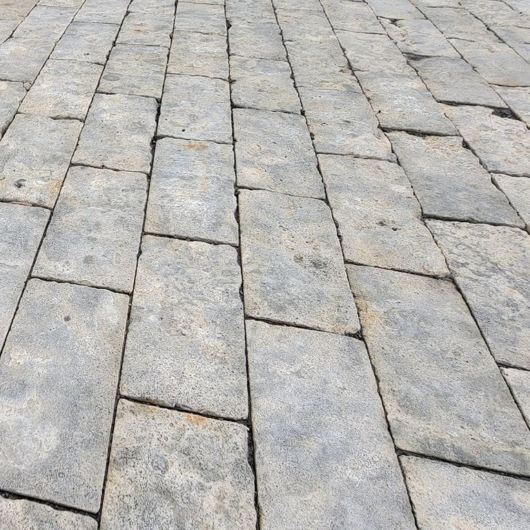 Application image for Limestone - Reclaimed Rochester Pavers. The image shows this product being used for driveway pavers, path pavers, patio pavers and driveway aprons. The surface finish shown is split-face. The dominant color shown is gray.