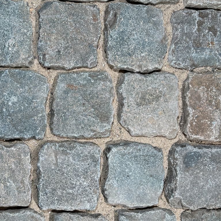 Color/Finish variation image for Reclaimed European Porphyry Cobblestones - Square - Worn Surface. The surface finish shown is . Dominant colors shown are gray and greige. The color mix creates a cool feeling.