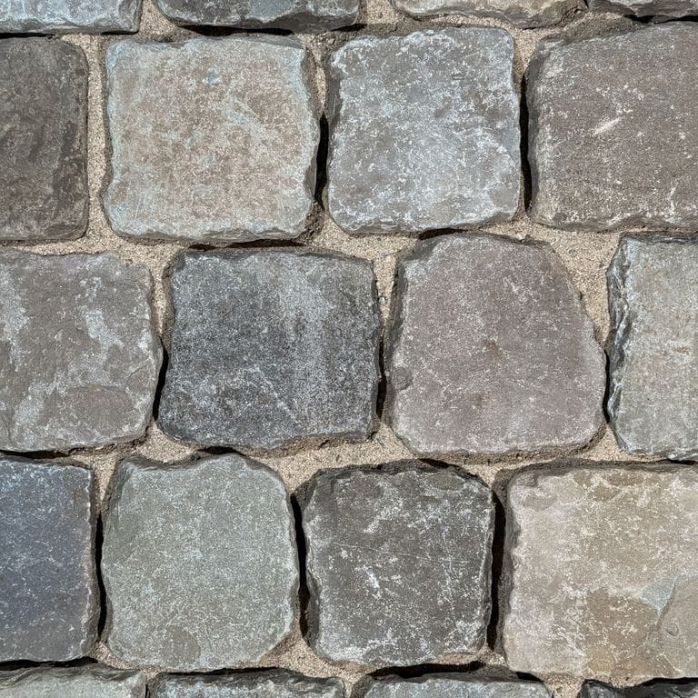 Color/Finish variation image for Reclaimed European Sandstone Cobblestones - Square - Worn Surface. The surface finish shown is . The dominant color shown is gray. The color mix creates a cool feeling.
