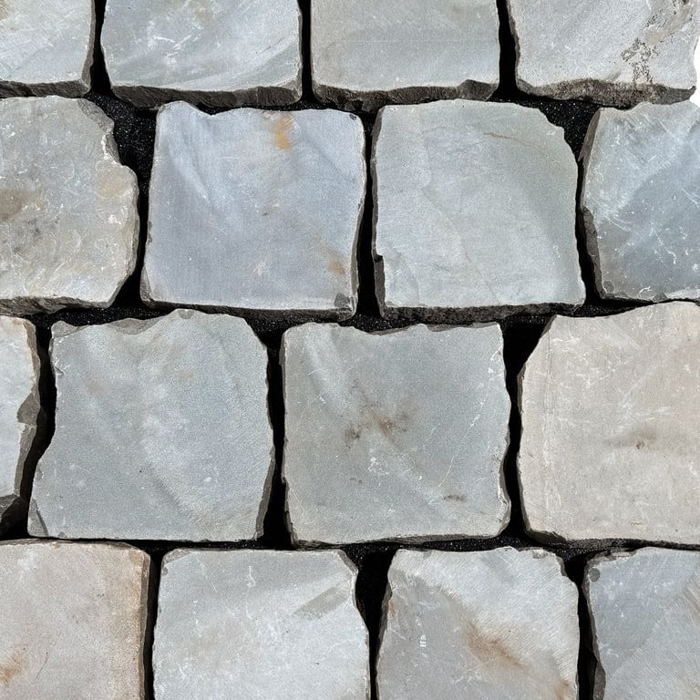 Color/Finish variation image for Reclaimed European Sandstone Cobblestones - Square - Flat Surface. The surface finish shown is sawn. The dominant color shown is gray. The color mix creates a cool feeling.
