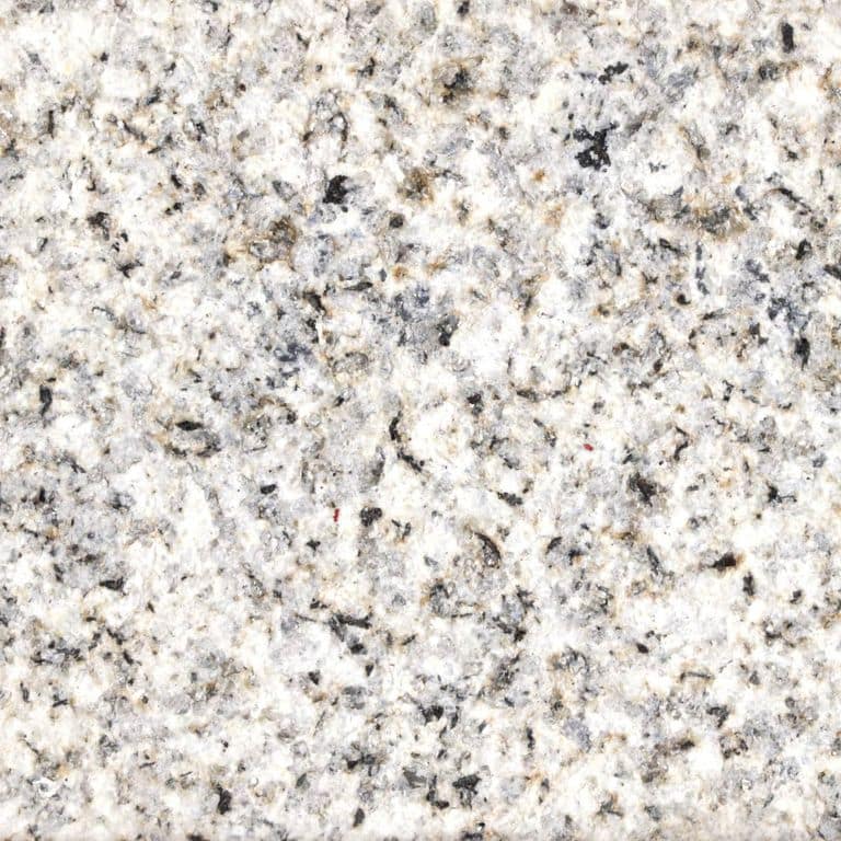 Color/Finish variation image for Yellow Oat Granite - Cobblestones. The surface finish shown is sand blasted. Dominant colors shown are gray, white and cream; with beige and tan secondaries. The color mix creates a warm feeling. Blotched and coarse speckled color patterns. Contains some mica and mineral inclusions.