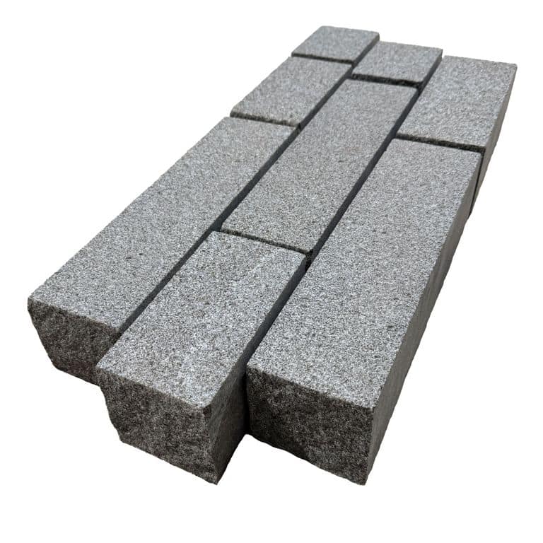 Color/Finish variation image for Republic Black Granite - Cobblestones. The surface finish shown is sand blasted. The dominant color shown is gray. The color mix creates a cool feeling.
