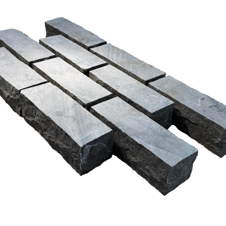Feature image for Limestone - Highland Cobblestone - Rectangle - Sawn Top, Split Sides. The surface finish shown is sawn. Dominant colors shown are black and gray. The color mix creates a cool feeling.