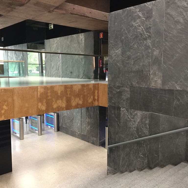 Application image for Slate - Iberian Gray - Veneer. The image shows this product being used for thin veneer and interior cladding. The dominant color shown is gray. Exhibits "movement". Veined color pattern.