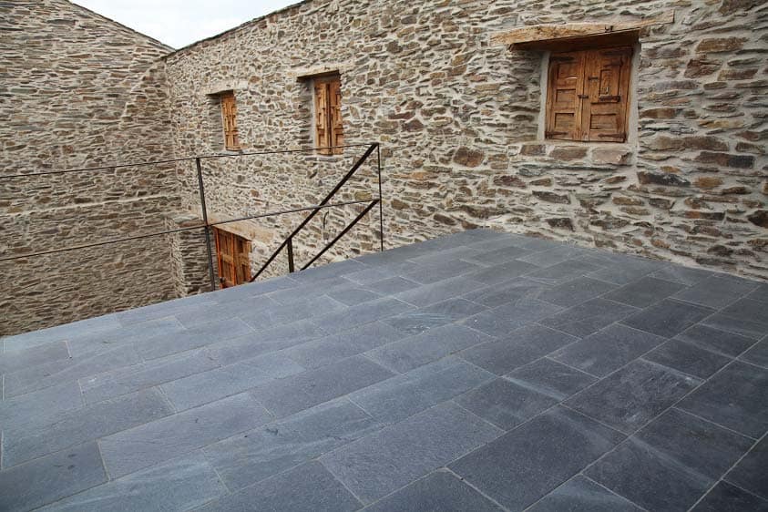 Application image for Slate - Iberian Gray - Pavers. The image shows this product being used in a patio pavers application. Dominant colors shown are black and gray. The color mix creates a cool feeling.