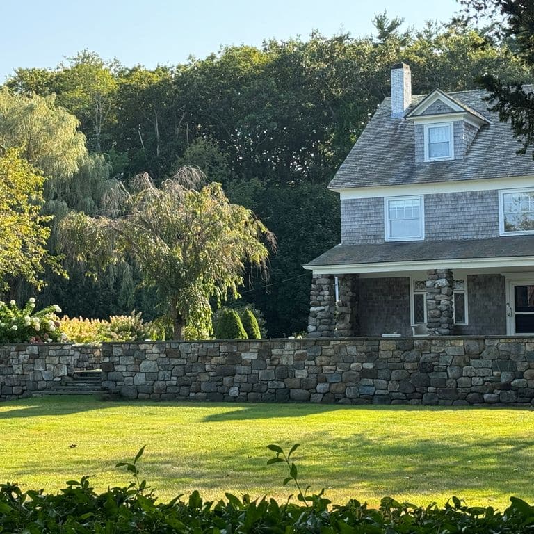 Application image for New England Fieldstone Mix - Veneer. The image shows this product being used in a full bed veneer application. The surface finish shown is weathered. The dominant color shown is gray.