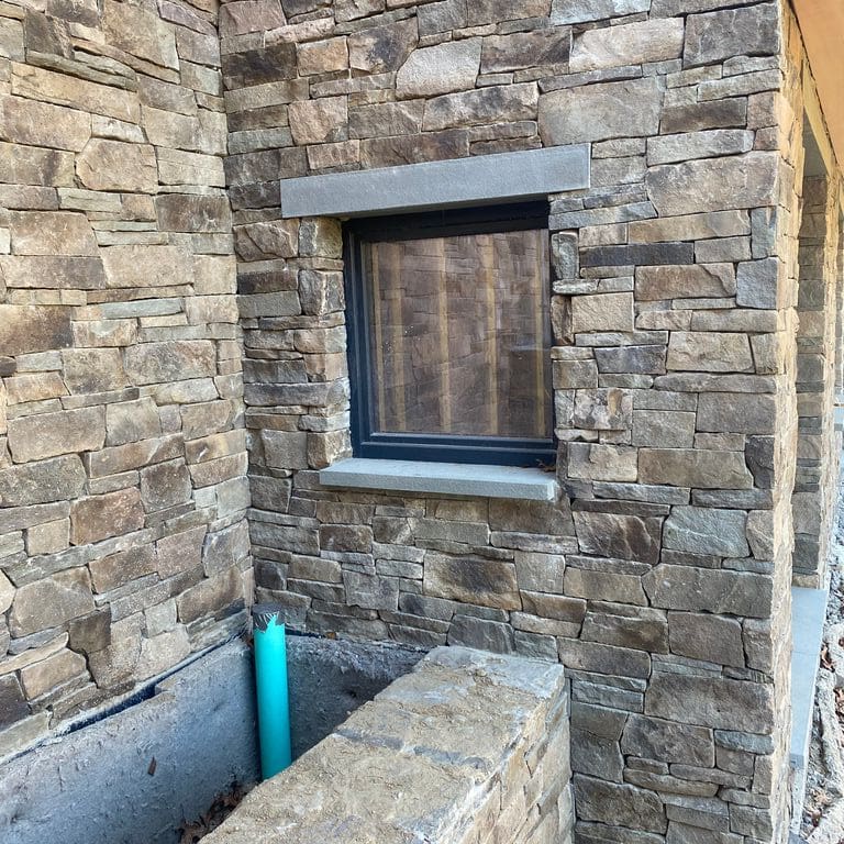 Feature image for Fieldstone - Pennsylvania - Veneer. The image shows this product being used in a thin veneer application. The surface finish shown is split-face. Dominant colors shown are gray and tan.
