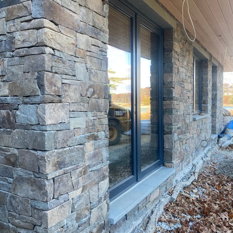 Application image for Fieldstone - Pennsylvania - Veneer. The image shows this product being used in a thin veneer application. The surface finish shown is split-face. Dominant colors shown are gray and tan.