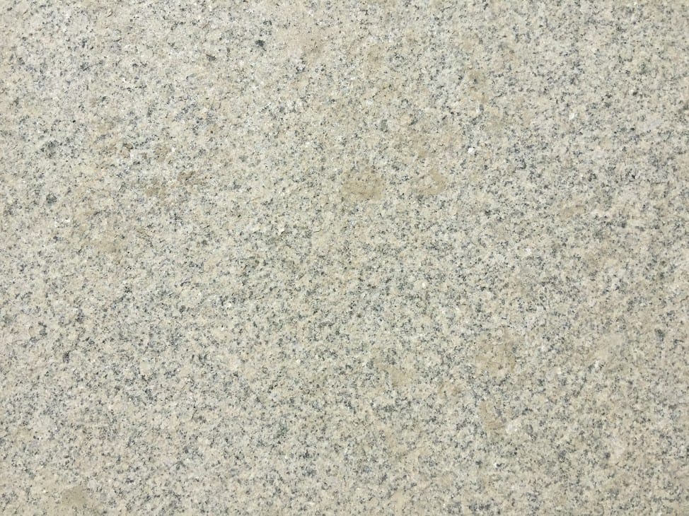 Color/Finish variation image for Cape Neddick Granite Clear - Rockfaced Steps. Dominant colors shown are beige and gray; with green, white, tan and cream secondaries. The color mix creates a warm feeling. Speckled color pattern.