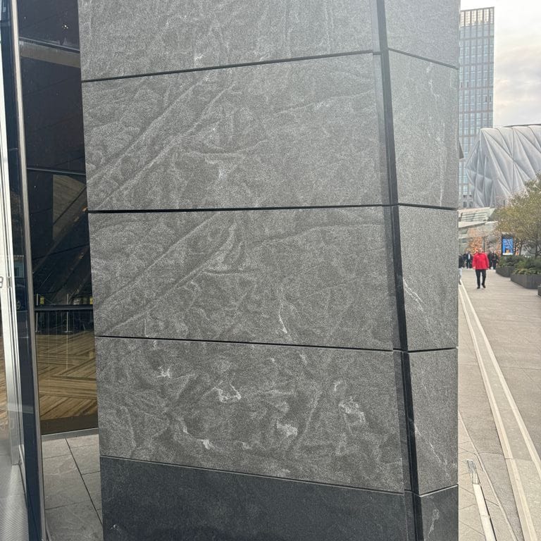Application image for Jet Mist Granite - Wall Cladding. The image shows this product being used in an interior cladding application. The dominant color shown is gray.