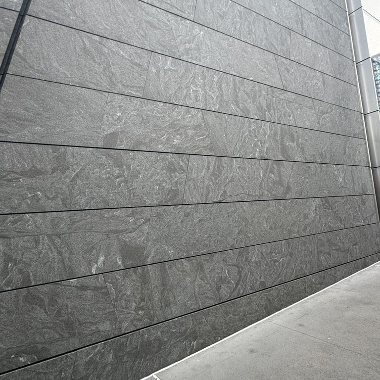 Application image for Jet Mist Granite - Wall Cladding. The image shows this product being used in an interior cladding application. The dominant color shown is gray. The color mix creates a cool feeling.