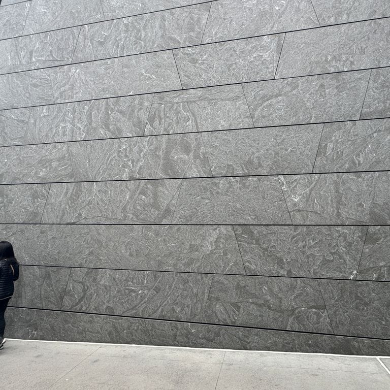 Application image for Jet Mist Granite - Wall Cladding. The image shows this product being used in an interior cladding application. The dominant color shown is gray. The color mix creates a cool feeling.