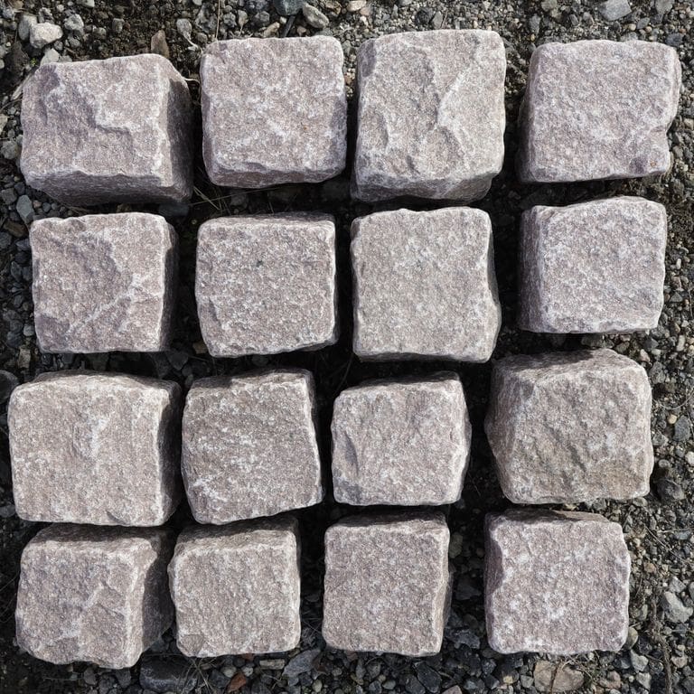 Feature image for Dusty Rose Granite Cobblestone - Squares. The surface finish shown is . Dominant colors shown are pink and red.