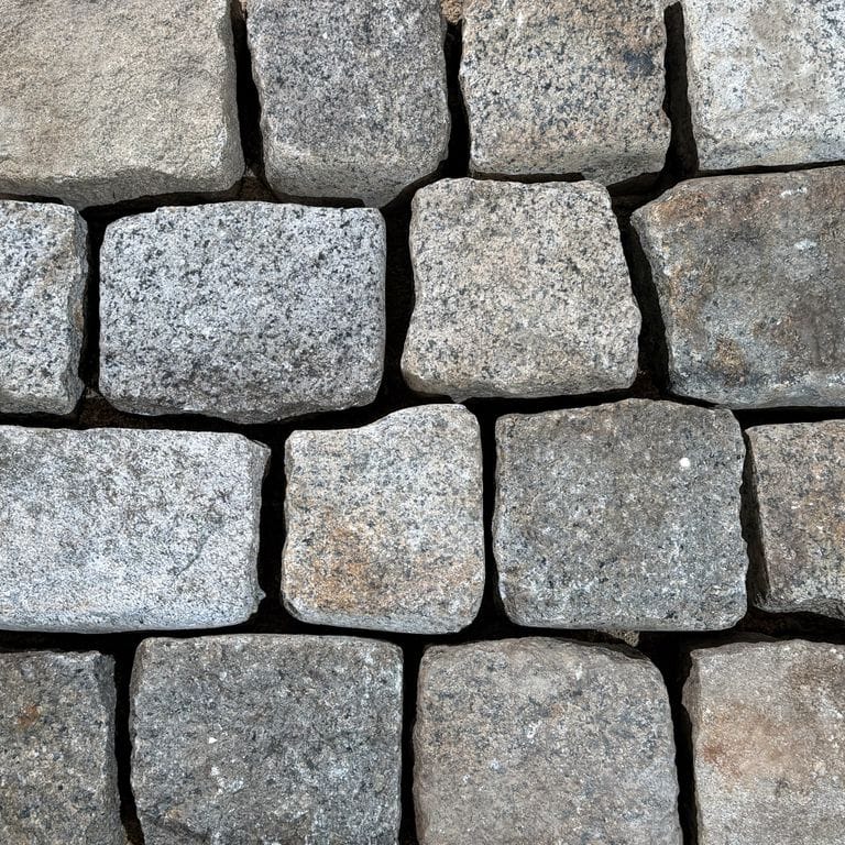 Color/Finish variation image for Reclaimed New England Cobblestones - Medium Wide Side. The surface finish shown is . Dominant colors shown are gray and greige. The color mix creates a cool feeling.