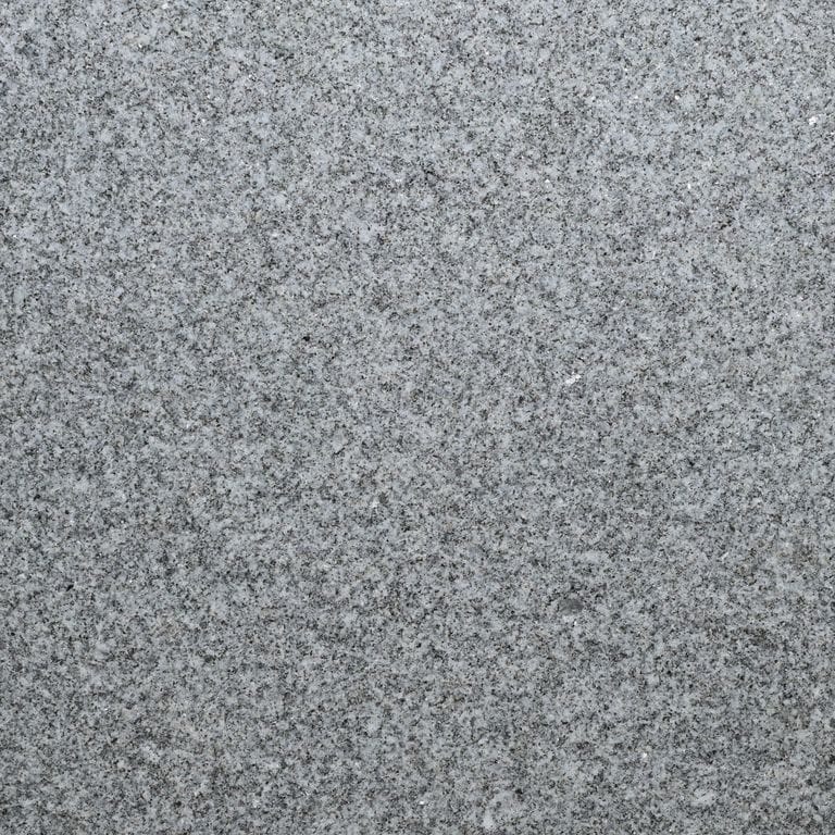 Color/Finish variation image for Gray Nisa Granite - Pavers. The surface finish shown is flamed. The dominant color shown is gray. The color mix creates a cool feeling.
