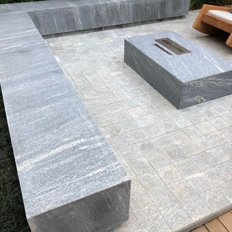 Application image for Brazilian Lucerna Gneiss - Flamed Pavers. The image shows this product being used in a patio pavers application. The surface finish shown is flamed. The dominant color shown is gray. The color mix creates a warm feeling.