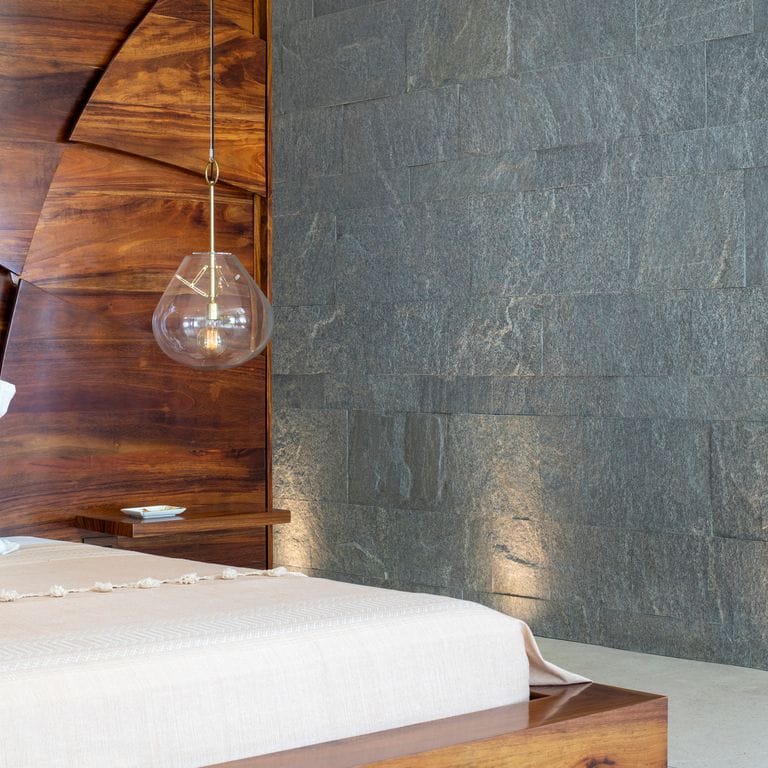 Application image for Brazilian Lucerna Gneiss - Interior Wall Cladding. The image shows this product being used in an interior cladding application. The surface finish shown is split-face. The dominant color shown is gray. The color mix creates a warm feeling.