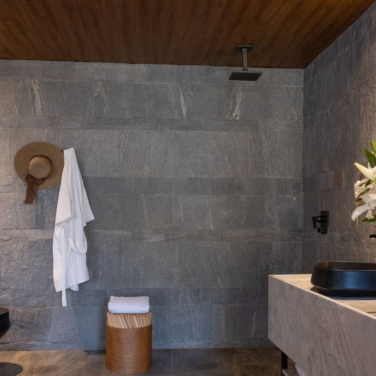 Application image for Brazilian Lucerna Gneiss - Interior Wall Cladding. The image shows this product being used in an interior cladding application. The surface finish shown is split-face. The dominant color shown is gray. The color mix creates a cool feeling.