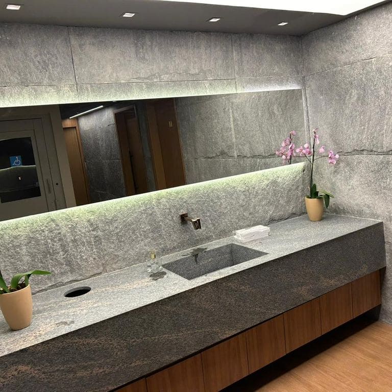 Application image for Brazilian Lucerna Gneiss - Interior Wall Cladding. The image shows this product being used in an interior cladding application. The surface finish shown is split-face. The dominant color shown is gray. The color mix creates a warm feeling.