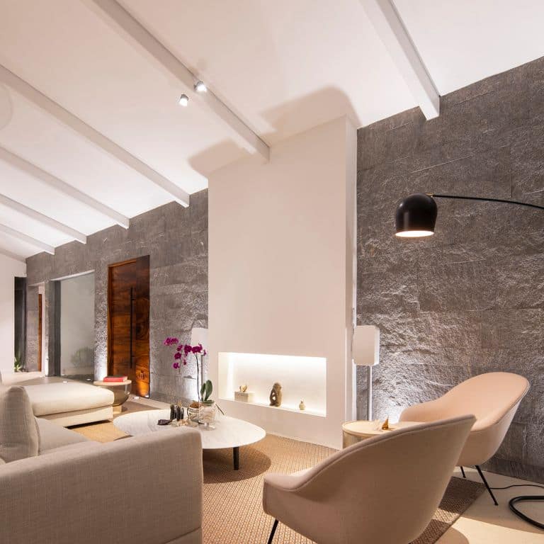 Application image for Brazilian Lucerna Gneiss - Interior Wall Cladding. The image shows this product being used in an interior cladding application. The surface finish shown is split-face. The dominant color shown is gray. The color mix creates a warm feeling.