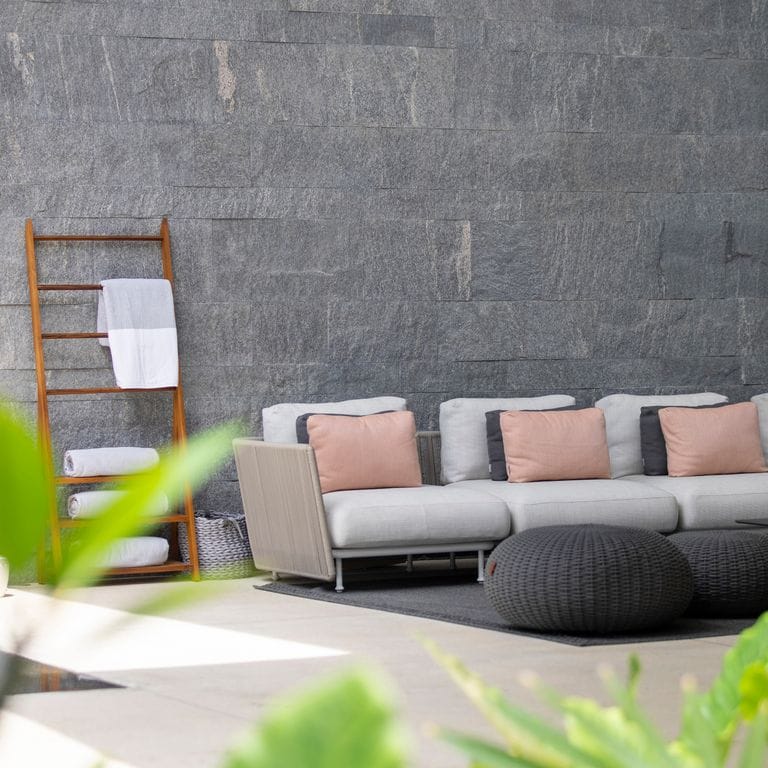 Application image for Brazilian Lucerna Gneiss - Cut to Size Veneer. The image shows this product being used in a full bed veneer application. The surface finish shown is split-face. The dominant color shown is gray. The color mix creates a warm feeling.