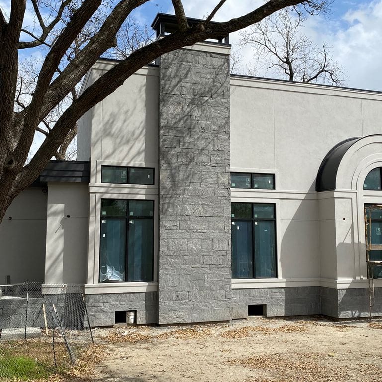 Application image for Brazilian Lucerna Gneiss - Veneer. The image shows this product being used in a full bed veneer application. The surface finish shown is split-face. The dominant color shown is gray.