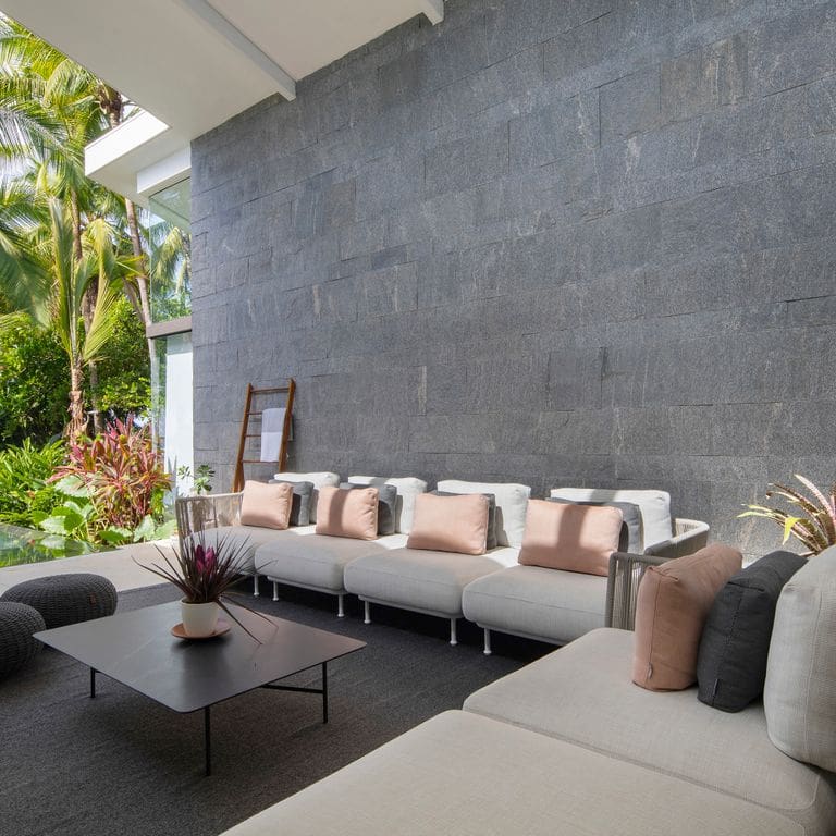 Application image for Brazilian Lucerna Gneiss - Cut to Size Veneer. The image shows this product being used in a full bed veneer application. The surface finish shown is split-face. The dominant color shown is gray. The color mix creates a warm feeling.