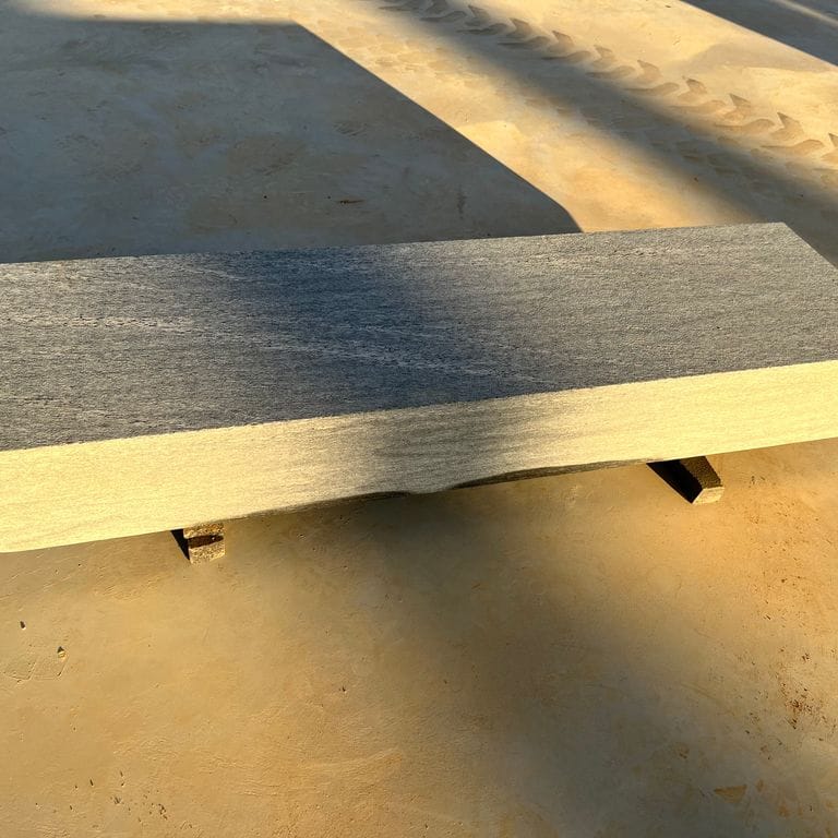 Application image for Brazilian Lucerna Gneiss - Benches. The image shows this product being used in a seating &amp; benches application. The surface finish shown is flamed. The dominant color shown is gray. The color mix creates a cool feeling.