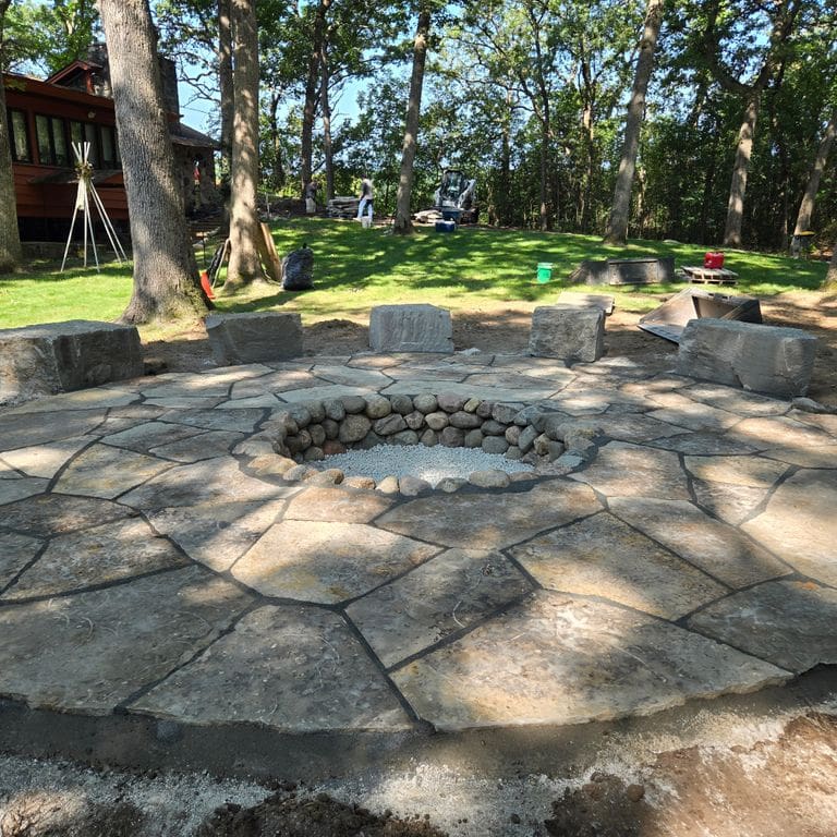 Application image for Madison Limestone - Irregular Pavers. The image shows this product being used in a patio pavers application. The surface finish shown is flamed. The dominant color shown is gray. The color mix creates a warm feeling.