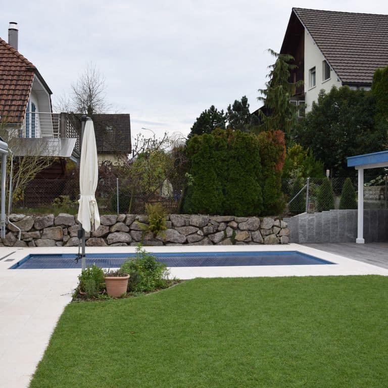 Application image for Veneto Beige Limestone - Pool Coping. The image shows this product being used for pool coping and pool deck pavers. The surface finish shown is flamed. Dominant colors shown are beige, tan and cream. The color mix creates a warm feeling.