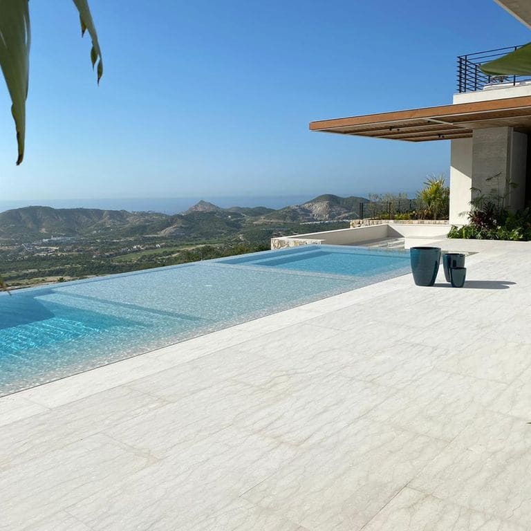 Application image for Veneto Beige Limestone - Pool Coping. The image shows this product being used for pool coping and pool deck pavers. Dominant colors shown are beige and cream. The color mix creates a cool feeling.